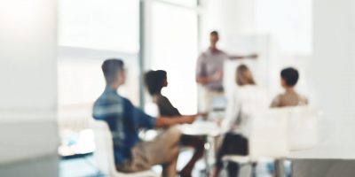 Defocused shot of a group of businesspeople having a meeting in an office